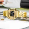 A gold Casio digital watch with a metal band is displayed on a surface with a blurred background. Podgląd zdjęcia produktu
