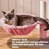 A cat is resting in a pink hammock attached to a cat tree. Produktbild-Vorschau