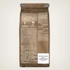 The back of a coffee bag with text and branding. Náhled obrázku produktu