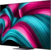 A close-up, angled view of a large television screen displaying a vibrant, abstract, swirling pattern of pink and teal colors against a black background. The bottom of the TV with its stand is visible. Produktbild-Vorschau