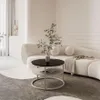 A modern living room with a curved sofa and a round coffee table. Produktbild-Vorschau