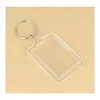 A clear acrylic keychain with a rectangular photo frame is shown on a light brown textured background. Produktbild-Vorschau