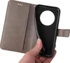 A hand holding a gray flip phone case with a floral pattern, revealing the black interior where a phone would be placed. Produktbild-Vorschau