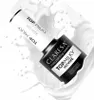 A bottle of Claresa Top Milky No Wipe nail polish is shown in a splash of white liquid. Náhled obrázku produktu