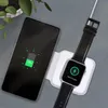 A smartphone and a smartwatch are charging on a white wireless charging pad, placed on a gray surface. A plant is visible in the background. Produktbild-Vorschau