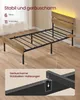A single bed frame with a wooden headboard and footboard, shown in a room with wooden flooring. A close-up inset shows a detail of the bed frame's support structure. Produktbild-Vorschau