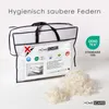 A product shot of a duvet in its packaging, with loose feathers in the foreground and marketing text and logos. Produktbild-Vorschau