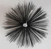 A top-down view of a chimney brush with black bristles radiating outwards from a central silver screw. Produktbild-Vorschau