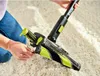 A person is using a cordless vacuum cleaner on a carpeted floor. Produktbild-Vorschau