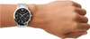 A person's wrist wearing a silver Emporio Armani watch with a black dial. Náhled obrázku produktu