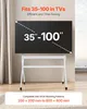A TV stand with a TV mounted on it, in a room with a window and curtains. Anteprima dell’immagine prodotto