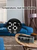 A digital clock with temperature display on a coffee table in a living room. Podgląd zdjęcia produktu