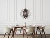 A dining room with a wooden table and chairs, illuminated by a pendant light. Náhled obrázku produktu