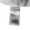 A close-up of a product label with care instructions and company information. Produktbild-Vorschau