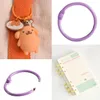 A collage of four images showing different views and items related to binder rings and a keychain. Produktbild-Vorschau