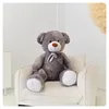 A large teddy bear sitting on a chair in a room. Podgląd zdjęcia produktu