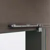 A close-up view of a sliding glass door mechanism attached to a wall and a glass door. Produktbild-Vorschau