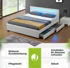 A white upholstered bed with LED lighting and storage drawers in a bedroom setting. Produktbild-Vorschau