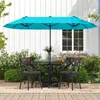 An outdoor patio scene with a table and chairs set up under a large turquoise umbrella. Produktbild-Vorschau