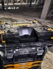 A DeWALT TSTAK radio sits on a construction site floor. Produktbild-Vorschau