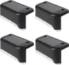 Four black solar-powered LED step lights are arranged in a 2x2 grid against a white background. Produktbild-Vorschau