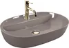 A beige oval sink with a gold faucet against a white background. Náhled obrázku produktu