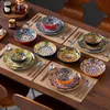 A table setting with colorful bohemian-style dinnerware. Náhled obrázku produktu