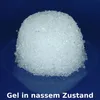 A close-up, slightly angled shot of a mound of white granular material on a dark blue surface, with text at the bottom. Produktbild-Vorschau