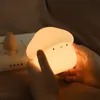 Hands holding a glowing mushroom-shaped night light. Podgląd zdjęcia produktu