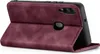A burgundy flip cover case for a smartphone is shown open, revealing the phone inside. Produktbild-Vorschau