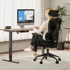 A woman is sitting at a desk and working on a computer. Produktbild-Vorschau