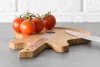A wooden cutting board shaped like a guitar with tomatoes and a knife on it. Náhľad obrázku produktu