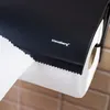 A close-up shot of a black paper towel holder with a roll of white paper towels attached. Produktbild-Vorschau
