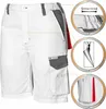A pair of white work shorts with gray accents and red detailing, shown with close-up insets highlighting features like stretch fabric, a zipper, and a pocket detail. Produktbild-Vorschau