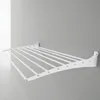 A white aluminum wall-mounted drying rack is shown against a light gray wall. Produktbild-Vorschau