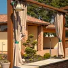 Outdoor pergola with beige curtains, decorative plants, and lighting. Produktbild-Vorschau