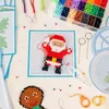 A flat lay of a Christmas-themed perler bead craft kit, showing a Santa Claus and gingerbread man design in progress, along with beads, pegboards, and tools. Produktbild-Vorschau