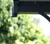 Water dripping from a gutter downspout. Voir les images du produit