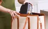 A person is placing a small appliance into a large tote bag. Anteprima dell’immagine prodotto