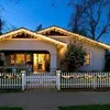A house decorated with Christmas lights at dusk. Voir les images du produit