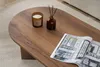 A coffee table with a candle, diffuser, and magazine on it, placed on a rug. Produktbild-Vorschau