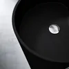 A close-up view of a black sink with a chrome drain. Produktbild-Vorschau