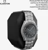 A watch is displayed on a black hexagonal stand, with text and a logo in the background. Produktbild-Vorschau