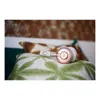 Headphones resting on a patterned pillow. Produktbild-Vorschau
