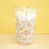 A clear plastic bag filled with disposable food covers, set against a yellow and light beige background. Produktbild-Vorschau
