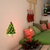 A festive Christmas-themed room with a night light, stockings, pillows, and a candle. Náhľad obrázku produktu