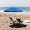 A beach scene with two chairs, an umbrella, and a cooler. Anteprima dell’immagine prodotto