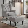 A grey armchair and ottoman are shown on a rug in a room. Náhled obrázku produktu
