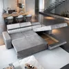 A modern living room with a sofa bed extended to show storage, a dining table and chairs, and stairs. Produktbild-Vorschau