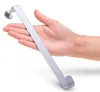 A hand is holding a silver metal door hook against a white background. Produktbild-Vorschau